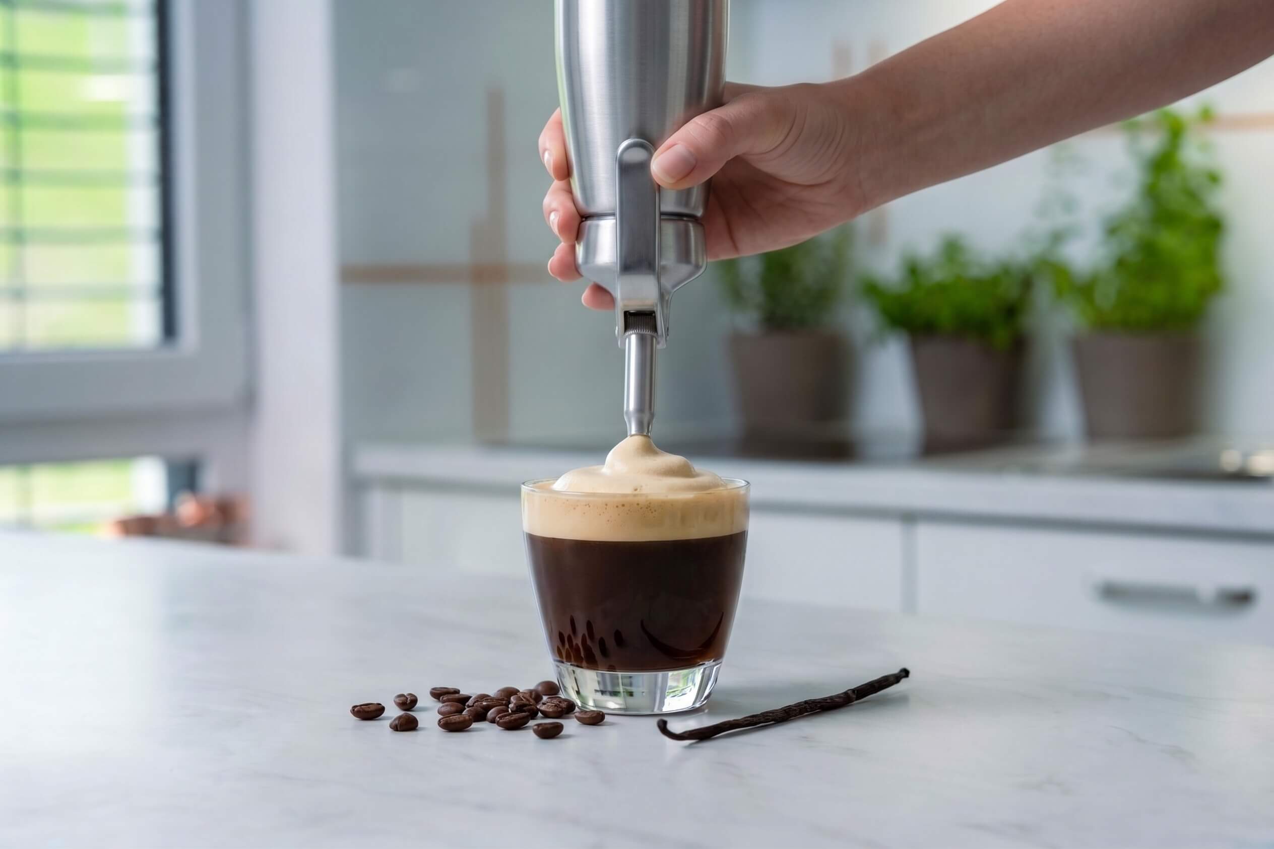 A carajillo made with coffee foam and vanilla beans being made